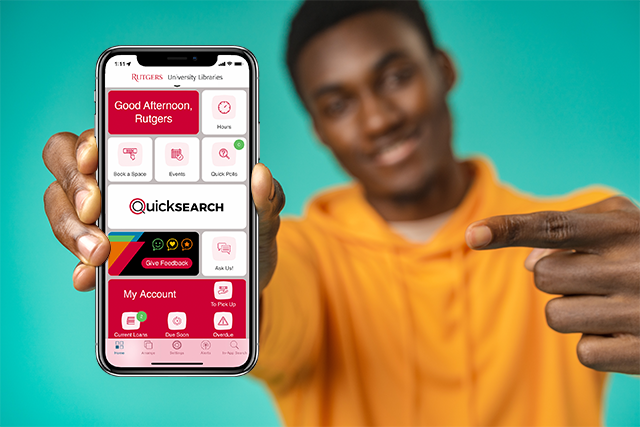 Student pointing at phone displaying Library Mobile App Student pointing at phone displaying Library Mobile App
