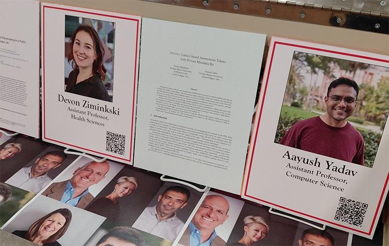 Image of a Robeson Library display case featuring headshots of new faculty members and examples of their scholarship
