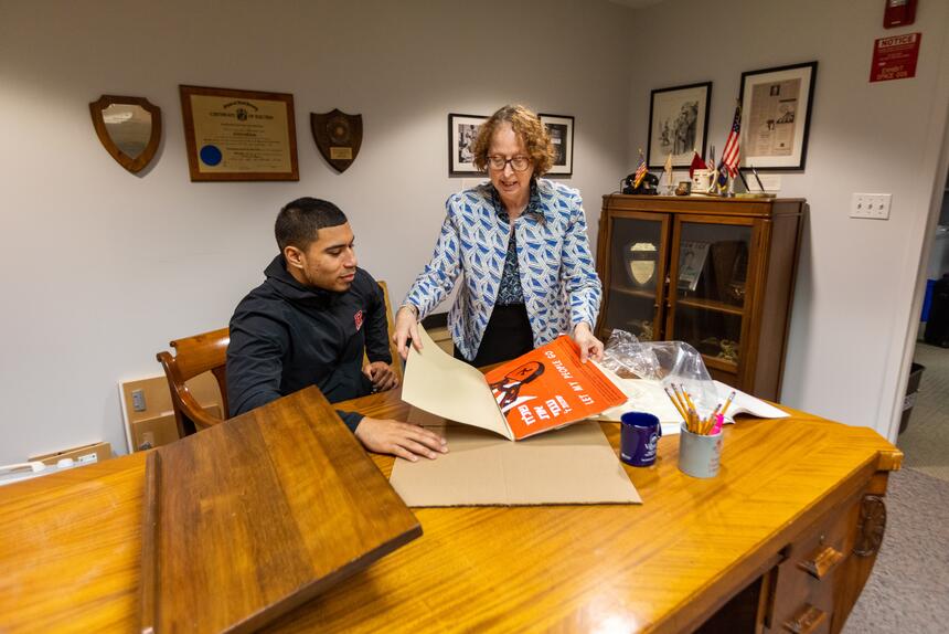 SCUA staff member helping a student with poster collections