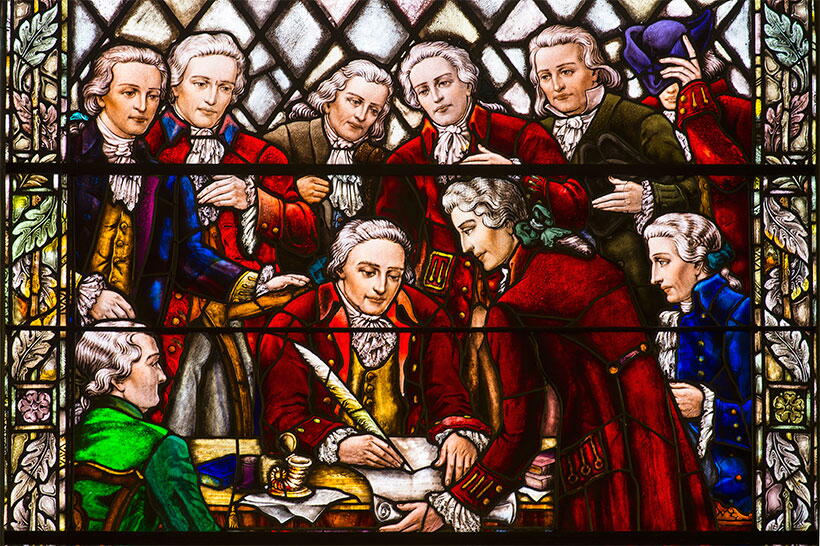 Stained-glass window in Kirkpatrick Chapel depicting William Franklin, Royal Governor of New Jersey, signing the Queen's College charter in 1766.