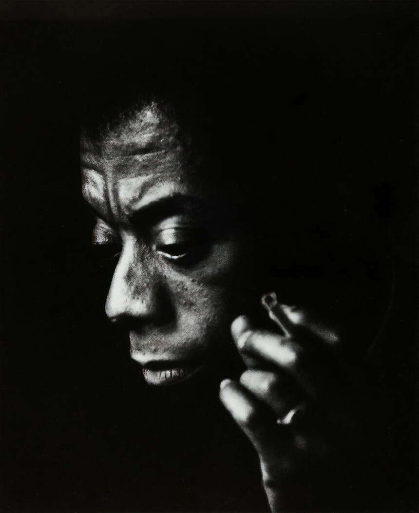 James Baldin profile, dark phtoto, smoking cigarette