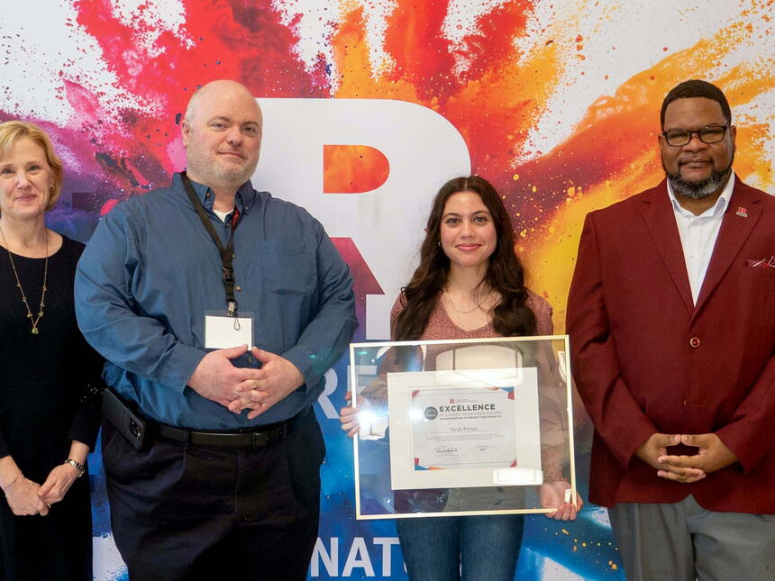 Sarah Ramos accepting award certificate