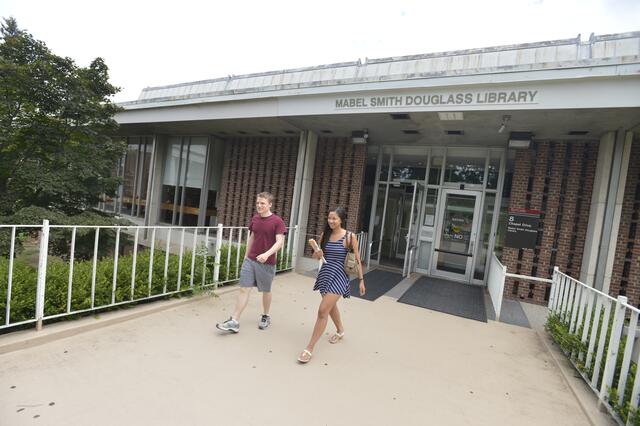Exterior of Douglass Library with two students walking out
