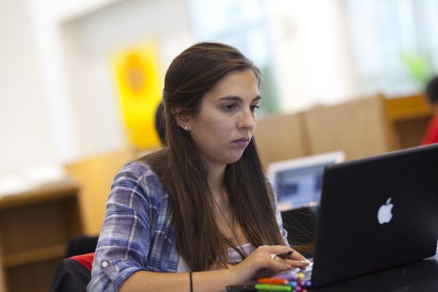 A student uses her laptop in Alexander Library's Undergraduate Reading Room
