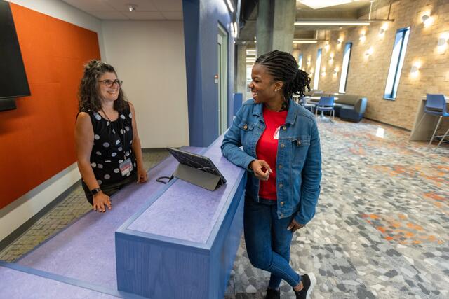 Photo of a Dana staff member helping a student at the circulation desk