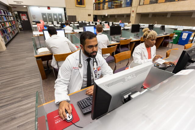Students in the Smith library working on computers in the main Smith area