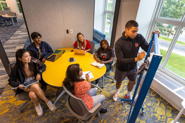 Students working at a whiteboard in the Digital Learning Commons at Alexander Library