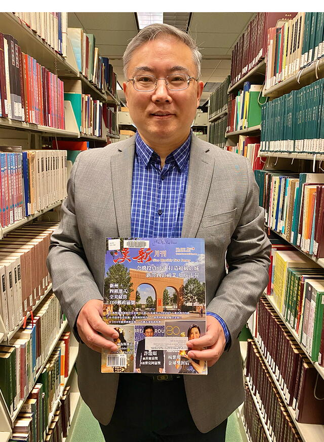 Librarian Tao Yang with a copy of Sino Monthly in the East Asian Library.