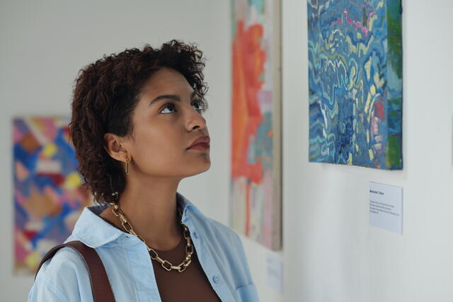 Image of a woman looking at art in a musuem
