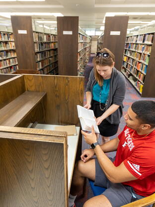 A Carr staff member helps a student with their needs