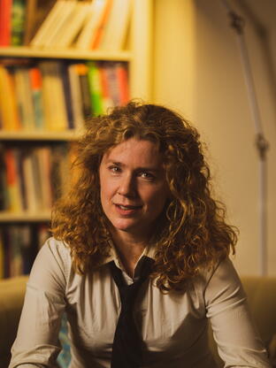 Francesca Giannetti seated in front of a bookshelf