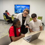 Photo of a Dana staff member helping students in the study room space