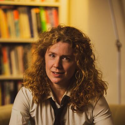 Francesca Giannetti seated in front of a bookshelf