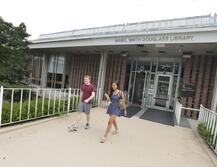 Exterior of Douglass Library with two students walking out