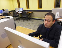 A student works on a Mac computer in Douglass Library's Fordham Lab