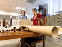 Librarian and student search archives in Special Collections and University Archives