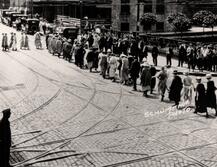 City street photograph showing women lined up to vote