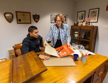 SCUA staff member helping a student with poster collections