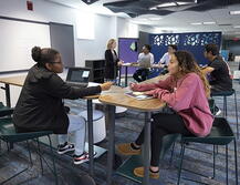 A group at one of the conference tables in the Hatchery