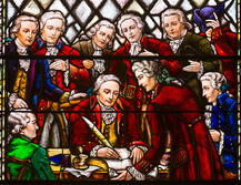 Stained-glass window in Kirkpatrick Chapel depicting William Franklin, Royal Governor of New Jersey, signing the Queen's College charter in 1766.