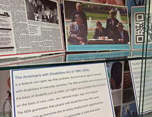 Detail of the ADA Anniversary Exhibit: Picture includes images of President Bush signing the bill, a clipping form a newspaper, and a textual card about the ADA.