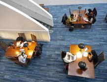 students working at tables in AlexAnder Library's lower atrium study area