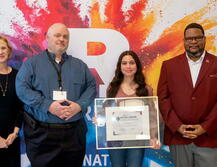 Sarah Ramos accepting award certificate